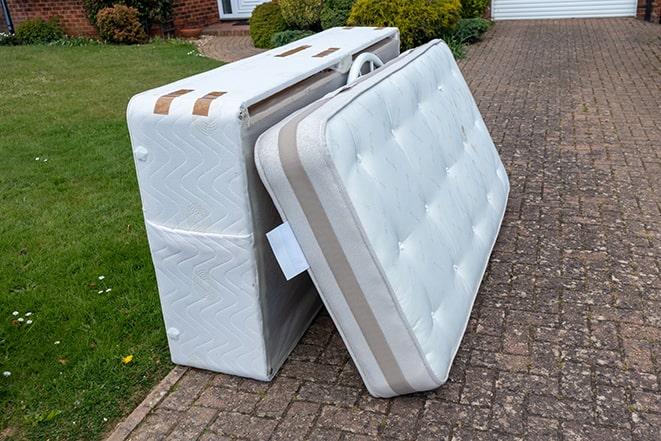 unwanted mattress being hauled away by professionals